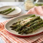 Air Fryer Asparagus Parmesan served crispy with melted cheese on top.