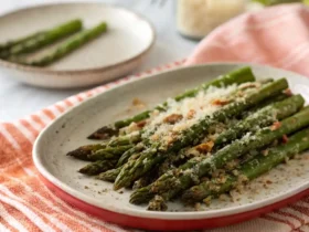Air Fryer Asparagus Parmesan served crispy with melted cheese on top.