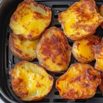 Golden smashed potatoes cooking inside the air fryer crispy and irresistible!