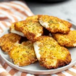 Crispy golden air fried mozzarella slices on a plate