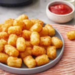 Crispy golden air fryer tater tots on a plate