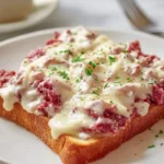 Delicious Creamed Chipped Beef on Toast, smothered in a creamy white sauce and melted cheese, garnished with fresh parsley.