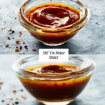 A close-up of a small glass bowl filled with rich, spicy Shut Yo Mouth Sauce, surrounded by scattered chili flakes on a textured grey surface.