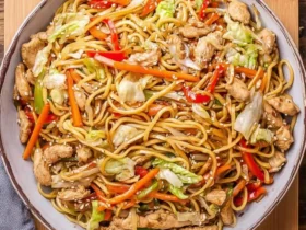 A close-up view of a large bowl filled with delicious Chicken Yakisoba, featuring stir-fried noodles, chicken, and colorful vegetables.