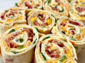 Delicious pinwheel appetizers filled with cream cheese, bacon, and veggies, perfect to Pin on yummy stuff for your next gathering.