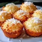 A plate of delicious Portuguese Coconut Cakes, golden brown and topped with shredded coconut flakes, ready to be enjoyed.