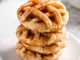 Apple Pie Cookies 55 Stack of three cinnamon-sugar Apple Pie Cookies on a white plate with marble background.