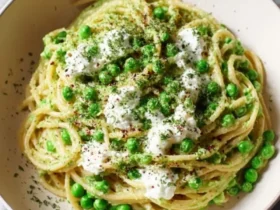 Pea and Ricotta Pasta 38 A bowl of Pea and Ricotta Pasta with creamy green sauce, fresh peas, and dollops of ricotta cheese on top.