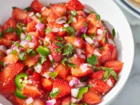 Fresh Strawberry Jalapeño Salsa in a white bowl with diced strawberries, red onion, cilantro, and jalapeño slices.