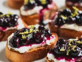 Blueberry & Goat Cheese Crostini Recipe 50 Blueberry & Goat Cheese Crostini Recipe featuring toasted bread topped with creamy goat cheese, glazed blueberries, and lemon zest.