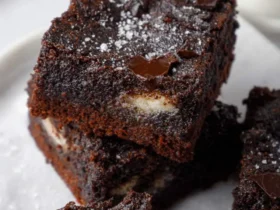 cottage cheese brownies 44 Stack of rich, fudgy cottage cheese brownies topped with chocolate chunks and flaky sea salt.