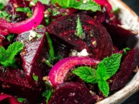Moroccan Beet Salad with sliced beets, red onions, fresh mint, and spices in a rustic ceramic bowl.