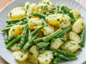 No Mayo Potato Salad With Green Beans 50 A plate of no mayo potato salad with green beans, featuring tender potatoes and crisp beans tossed in a fresh herb dressing.