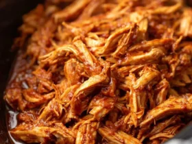 Shredded BBQ chicken crockpot filled with tender, saucy pulled chicken ready to serve.